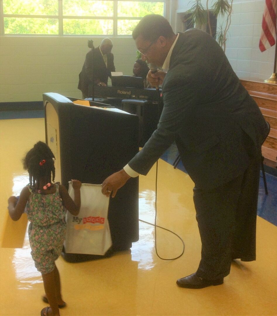 A man and child in front of a podium.